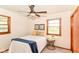 Well-lit bedroom featuring a ceiling fan, two windows, and hardwood trim at 7849 E 49Th St, Indianapolis, IN 46226