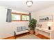 Cozy bedroom with natural light, wood floors, bench, and decor at 7849 E 49Th St, Indianapolis, IN 46226