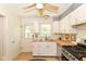 Cozy kitchen featuring white cabinets, butcher block countertops, and a stainless steel gas range at 7849 E 49Th St, Indianapolis, IN 46226