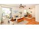Cozy living room featuring hardwood floors, ceiling fan, and natural light from bay window at 7849 E 49Th St, Indianapolis, IN 46226