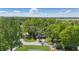An aerial view of a single story home with mature trees, lawn, landscaping, and a long driveway at 807 Vasbinder Dr, Chesterfield, IN 46017