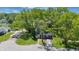 An aerial view of a single story home with a long driveway and mature trees in the front and back yards at 807 Vasbinder Dr, Chesterfield, IN 46017