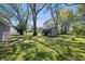 A backyard shed sits on a green lawn, surrounded by trees at 807 Vasbinder Dr, Chesterfield, IN 46017