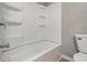 Bathroom features a white tub and shower combination with built-in shelving at 807 Vasbinder Dr, Chesterfield, IN 46017