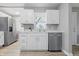 Bright kitchen with white cabinets, marble countertops, stainless steel dishwasher, and a new faucet at 807 Vasbinder Dr, Chesterfield, IN 46017