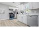 Updated kitchen featuring stainless steel appliances, white cabinets, new countertops, and a bright window at 807 Vasbinder Dr, Chesterfield, IN 46017