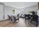Open-concept living area with comfortable seating, a dining area, and large windows for a bright and inviting space at 807 Vasbinder Dr, Chesterfield, IN 46017