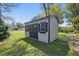 Well-maintained shed featuring siding and black shutters in a lush backyard at 807 Vasbinder Dr, Chesterfield, IN 46017