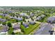 Aerial view of houses with green lawns and a peaceful pond in the neighborhood at 8178 Eskerban Dr, Avon, IN 46123