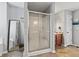 This bathroom features a tiled floor, a sliding door shower, and a large mirror at 8178 Eskerban Dr, Avon, IN 46123