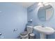 Powder blue bathroom with toilet, small vanity, toilet, and 'laughter' decal on the wall at 8178 Eskerban Dr, Avon, IN 46123