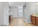 Bright bathroom featuring double sinks, a walk-in shower, and a soaking tub at 8178 Eskerban Dr, Avon, IN 46123