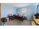 Cozy bedroom with blue walls, a small bed, accent lighting, a dresser and a window with natural light at 8178 Eskerban Dr, Avon, IN 46123
