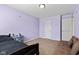 Cozy bedroom features light purple walls, carpet flooring, and a comfortable couch at 8178 Eskerban Dr, Avon, IN 46123