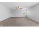 A spacious bedroom with plush carpeting, neutral walls, a ceiling fan, and a large window offering natural light at 8178 Eskerban Dr, Avon, IN 46123