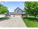 Charming two-story home with a three car garage, blue shutters and beautiful curb appeal at 8178 Eskerban Dr, Avon, IN 46123