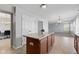 This kitchen features wood cabinets, tile flooring, neutral walls and an island with open views to other living spaces at 8178 Eskerban Dr, Avon, IN 46123