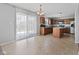 Open kitchen with stainless steel appliances, wooden cabinetry, tile backsplash, large sliding glass door and an island at 8178 Eskerban Dr, Avon, IN 46123