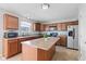 Bright kitchen with stainless appliances, ample wood cabinets, tile flooring, and a center island for entertaining at 8178 Eskerban Dr, Avon, IN 46123