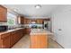 Well-equipped kitchen with stainless appliances, ample wood cabinets, tile flooring, and a center island for food prep at 8178 Eskerban Dr, Avon, IN 46123