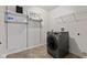 This laundry room features shelving, modern washer and dryer, and tile floors at 8178 Eskerban Dr, Avon, IN 46123