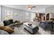 Bright living room featuring neutral color palette, modern decor, and seamless open floor plan to kitchen and dining area at 8178 Eskerban Dr, Avon, IN 46123
