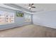 Spacious bedroom featuring a ceiling fan, tray ceiling, two windows, and a TV at 8178 Eskerban Dr, Avon, IN 46123