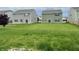 View of the backyard featuring a sprawling lawn surrounded by neighboring homes at 837 Sommersweet Run, Greenwood, IN 46143