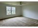 A bright bedroom with a large window and plush carpeting at 837 Sommersweet Run, Greenwood, IN 46143