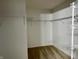A walk-in closet equipped with adjustable shelving and carpet flooring at 837 Sommersweet Run, Greenwood, IN 46143