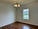 Well-lit dining room with hardwood floors and a classic chandelier fixture, offering ample natural light at 837 Sommersweet Run, Greenwood, IN 46143