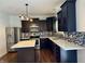 Modern kitchen with dark cabinetry, stainless steel appliances, mosaic backsplash, and center island at 837 Sommersweet Run, Greenwood, IN 46143