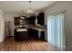 Open concept kitchen with dark cabinets, stainless steel appliances, and access to the backyard at 837 Sommersweet Run, Greenwood, IN 46143