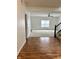 Bright living room with hardwood floors in the entryway and carpeted living space and open staircase at 837 Sommersweet Run, Greenwood, IN 46143