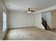 Spacious living room featuring plush carpeting, a ceiling fan, and staircase to the upper level at 837 Sommersweet Run, Greenwood, IN 46143