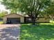 Charming single-story home featuring a well-maintained lawn, mature tree, and attached two-car garage at , Martinsville, IN 46151