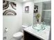 Modern bathroom featuring a vessel sink with decorative accents and artwork at 8835 Briarclift Rd, Indianapolis, IN 46256