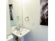 Bathroom featuring a pedestal sink and artistic wall decorations at 8835 Briarclift Rd, Indianapolis, IN 46256