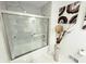 Bright bathroom with a glass-enclosed shower featuring marble-look tile at 8835 Briarclift Rd, Indianapolis, IN 46256