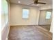 Cozy bedroom with a ceiling fan, two windows, and mirrored closet doors at 8835 Briarclift Rd, Indianapolis, IN 46256