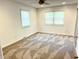Bright bedroom with a ceiling fan, two windows, and neutral carpeting at 8835 Briarclift Rd, Indianapolis, IN 46256