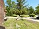 Charming front yard with mature trees, a decorative bird bath, and lush greenery at 8835 Briarclift Rd, Indianapolis, IN 46256