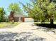 Charming single-story brick home with a spacious two-car garage and long driveway at 8835 Briarclift Rd, Indianapolis, IN 46256