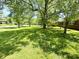 Expansive front yard featuring a healthy lawn and mature trees providing ample shade at 8835 Briarclift Rd, Indianapolis, IN 46256