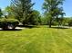 Manicured front lawn featuring mature trees offering plenty of shade and curb appeal at 8835 Briarclift Rd, Indianapolis, IN 46256