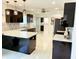Modern kitchen with dark cabinetry, white countertops, and stainless steel appliances at 8835 Briarclift Rd, Indianapolis, IN 46256
