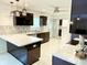 Modern kitchen with dark cabinetry, white countertops, and stainless steel appliances at 8835 Briarclift Rd, Indianapolis, IN 46256