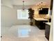 Open concept kitchen with dark cabinets and marble floors at 8835 Briarclift Rd, Indianapolis, IN 46256