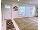 Inviting living room with front door and neutral carpet at 8835 Briarclift Rd, Indianapolis, IN 46256