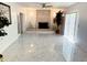 Bright living room with fireplace, marble floors, and lots of natural light at 8835 Briarclift Rd, Indianapolis, IN 46256